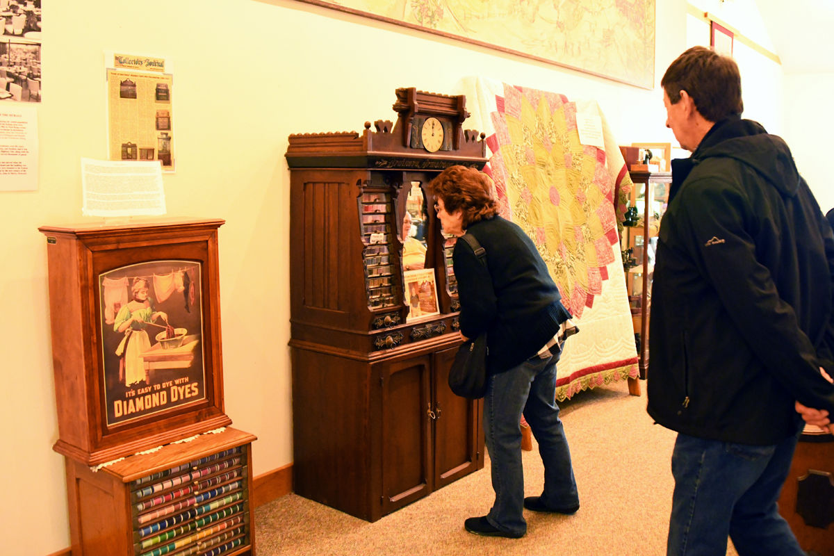 102 Angie and Jim Conner examine the spool cabinets at the Kalona Museum.JPG